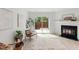 A bright living room features a fireplace and sliding glass door leading to the backyard at 2201 Alpine Rd, Durham, NC 27707