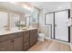 Modern bathroom featuring double vanity, glass shower, and wood style floor at 221 Steel Springs Ln # 23, Angier, NC 27501