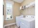 Well-lit laundry room featuring modern washer and dryer, shelving and window for natural light at 221 Steel Springs Ln # 23, Angier, NC 27501