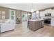 Bright kitchen with stainless steel appliances, open layout, and living room in background at 221 Steel Springs Ln # 23, Angier, NC 27501