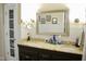 Bathroom featuring double sink vanity with a granite countertop, large mirror, and ample lighting at 2216 Countrywood North Rd, Raleigh, NC 27615
