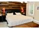 Bedroom featuring a king-sized bed, wood accent wall, and bedside tables with lamps at 2216 Countrywood North Rd, Raleigh, NC 27615