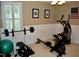Home gym featuring weightlifting equipment, cardio machines, and a mirrored wall at 2216 Countrywood North Rd, Raleigh, NC 27615