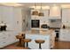 Bright kitchen with marble countertops, island with seating, stainless steel appliances, and custom cabinets at 2216 Countrywood North Rd, Raleigh, NC 27615