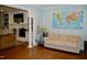 Open living space with a fireplace, comfortable seating, and a world map accent wall at 2216 Countrywood North Rd, Raleigh, NC 27615