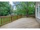 Large wooden back deck with a view of the green and beautifully landscaped backyard at 225 Norwalk St, Holly Springs, NC 27540