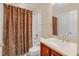Cozy bathroom with a vanity and shower with patterned curtain at 225 Norwalk St, Holly Springs, NC 27540
