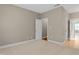 Carpeted bedroom with a doorway to another room and a neutral-toned wall color at 225 Norwalk St, Holly Springs, NC 27540