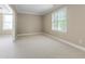 Bright bedroom features neutral carpet and walls with natural light from the window at 225 Norwalk St, Holly Springs, NC 27540