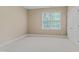 Neutral bedroom with large window allowing for natural light and plush carpet at 225 Norwalk St, Holly Springs, NC 27540