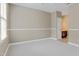 Spacious bedroom with neutral walls, light carpet, and a view into a bathroom at 225 Norwalk St, Holly Springs, NC 27540