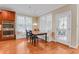 Eat-in kitchen area features a wooden table, a doorway, and window seating at 225 Norwalk St, Holly Springs, NC 27540