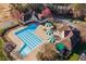 Aerial view of the community pool area with umbrellas and nearby buildings at 225 Norwalk St, Holly Springs, NC 27540