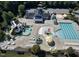 Aerial view of the community pool with lounge chairs, umbrellas, water slides and seating areas at 225 Norwalk St, Holly Springs, NC 27540