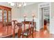 Formal dining room with hardwood floors, wainscoting, and a chandelier at 225 Norwalk St, Holly Springs, NC 27540
