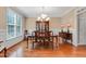 Formal dining room with hardwood floors, wainscoting, and a chandelier at 225 Norwalk St, Holly Springs, NC 27540