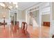 Formal dining room with hardwood floors, wainscoting, chandelier, and stairs in view at 225 Norwalk St, Holly Springs, NC 27540