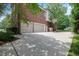 Spacious driveway with a basketball court leads to a three-car garage in brick home at 225 Norwalk St, Holly Springs, NC 27540