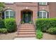 Elegant brick front steps lead to a charming front door with an arched brick entryway at 225 Norwalk St, Holly Springs, NC 27540
