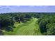 Aerial view of lush golf course winding through trees with home nestled within at 225 Norwalk St, Holly Springs, NC 27540
