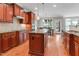Spacious kitchen featuring wood cabinets, granite countertops, a center island, and stainless steel appliances at 225 Norwalk St, Holly Springs, NC 27540