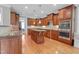 Gourmet kitchen with custom cabinets, granite countertops, and stainless steel appliances at 225 Norwalk St, Holly Springs, NC 27540