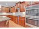 Gourmet kitchen with custom cabinets, granite countertops, and stainless steel appliances at 225 Norwalk St, Holly Springs, NC 27540