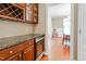 Granite countertops and wood cabinets with a wine cooler visible in this luxury kitchen at 225 Norwalk St, Holly Springs, NC 27540