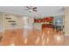 Open-concept living area with wood floors flows to the kitchen and eat-in breakfast area at 225 Norwalk St, Holly Springs, NC 27540