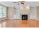 Cozy living room features wood floors, a fireplace with marble hearth, and built-in shelving at 225 Norwalk St, Holly Springs, NC 27540