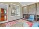 Relaxing screened porch featuring comfortable seating, colorful rug, and view to the backyard at 225 Norwalk St, Holly Springs, NC 27540