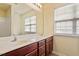Bathroom includes double sinks, vanity with a mirror and blinds at 229 Michigan Ave, Cary, NC 27519