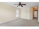 Light-filled bedroom showcases neutral walls, carpeted floors, a ceiling fan, and a window at 229 Michigan Ave, Cary, NC 27519