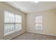 Sunlit bedroom with neutral walls, carpeted floor, and large windows offering plenty of natural light at 229 Michigan Ave, Cary, NC 27519