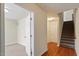 Bright entryway with hardwood floors, carpeted stairs, and a glimpse into the living space at 229 Michigan Ave, Cary, NC 27519