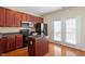 Kitchen featuring granite countertop, stainless steel appliances, and cherry cabinets at 229 Michigan Ave, Cary, NC 27519
