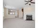 Open concept living room with fireplace, ceiling fan, and view to the kitchen at 229 Michigan Ave, Cary, NC 27519