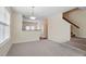 Living room area next to a counter looking into the kitchen with stairs to second floor at 229 Michigan Ave, Cary, NC 27519