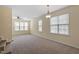 Spacious living room with carpet, many windows, and overhead lighting at 229 Michigan Ave, Cary, NC 27519