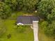 Aerial view of home with mature trees, landscaping, long driveway and backyard deck at 231 Harris Rd, Smithfield, NC 27577