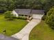 Aerial view of landscaped home featuring a long driveway and a two-car garage at 231 Harris Rd, Smithfield, NC 27577