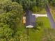 Aerial view showcases a well-maintained home featuring a new roof, a large deck, and beautifully landscaped grounds at 231 Harris Rd, Smithfield, NC 27577
