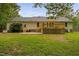 View of the house's back exterior with a wooden deck and a well-maintained lawn at 231 Harris Rd, Smithfield, NC 27577