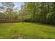Well-manicured backyard featuring a lush green lawn and a sturdy wooden fence at 231 Harris Rd, Smithfield, NC 27577