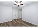 Bedroom featuring wood-look flooring, large closets, ceiling fan, and neutral color palette at 231 Harris Rd, Smithfield, NC 27577