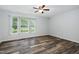 Bedroom featuring ceiling fan, wood-look flooring, and window with natural light at 231 Harris Rd, Smithfield, NC 27577