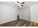 Bedroom with wood-look flooring, ceiling fan, and connecting door to another room at 231 Harris Rd, Smithfield, NC 27577