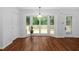 Bright dining area with bay window, wood floors, and access to deck at 231 Harris Rd, Smithfield, NC 27577