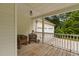 Cozy front porch with wicker furniture, overlooking the driveway and well-maintained yard at 231 Harris Rd, Smithfield, NC 27577