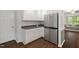 Kitchen with stainless steel refrigerator, sleek countertops, white cabinets and wood floor at 231 Harris Rd, Smithfield, NC 27577